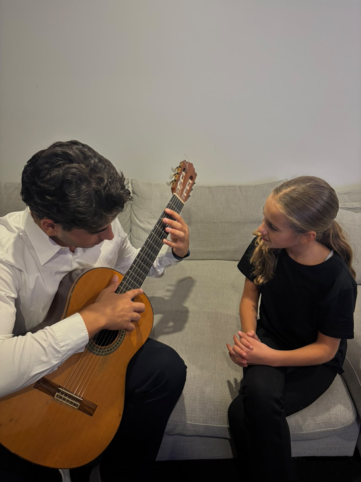 Sam Morgan teaching a young student classical guitar